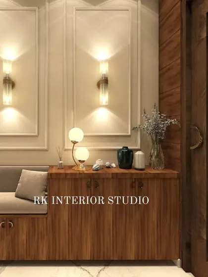 Another foyer concept, this one featuring a wooden shoe cabinet with an attached seating bench. The elegant wall mouldings and decorative lamps create a warm and sophisticated welcome.
