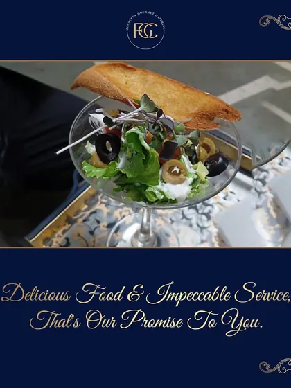 A classic Greek salad served with a modern twist in a stylish glass, topped with a piece of toasted bread. This dish shows how we elevate simple classics through thoughtful presentation.