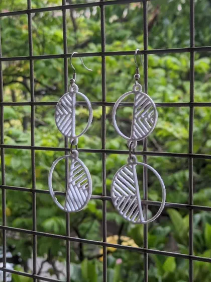 A pair of modern, geometric earrings made with our 3D printer, perfect for adding a unique touch to any outfit.