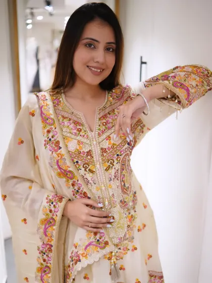Grace in every stitch, simplicity with a touch of royalty. This off-white suit with multi-color floral embroidery is a timeless piece.