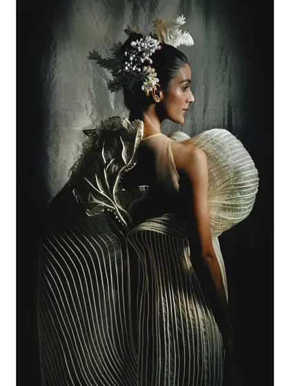 Another angle of the pleated white gown, showing the detail on the back. For brand campaigns, it's important to capture the garment from multiple viewpoints to tell its full story.