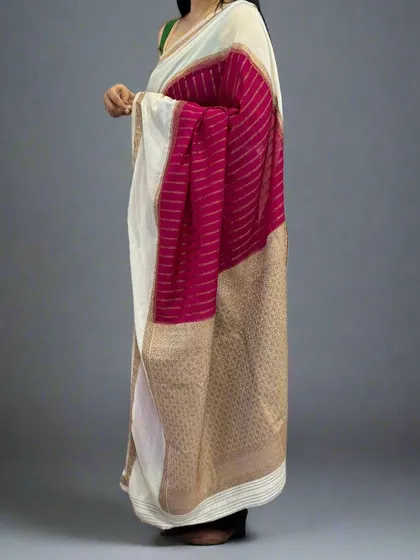 A side view of the rani pink and white semi-wrinkle crepe saree, showing the elegant drape.