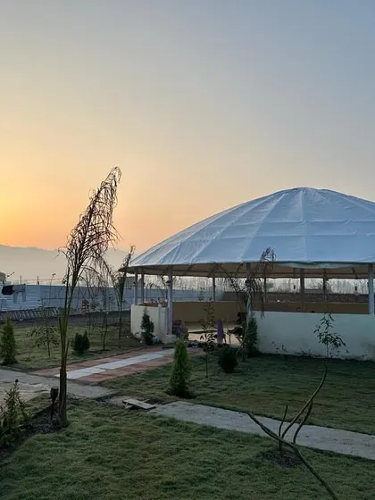 The beautiful, spacious yoga shala at our new Rishikesh school, set against the backdrop of a stunning sunrise. This is where you will practice and transform.