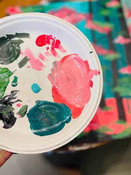 A close-up of a paint palette, showing the beautiful mess of colors that go into creating a masterpiece.