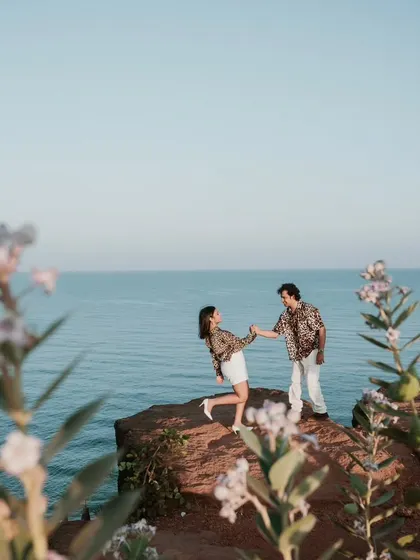 Standing on a cliff overlooking the sea in Goa, this shot captures a sense of adventure and romance. The beautiful coastal scenery provides a stunning backdrop for this destination pre-wedding photo.