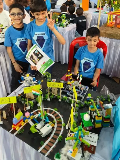 Team 'Lego Wizards' presenting their detailed LEGO model of a town celebrating different festivals. The project integrates multiple moving parts and demonstrates excellent planning and building skills.