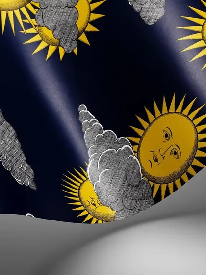 The iconic 'Soli e Nuvole' design by Piero Fornasetti for Cole & Son, featuring personified suns peeking through clouds. This close-up in a rich gold and black colorway highlights the whimsical yet dramatic nature of this timeless print.