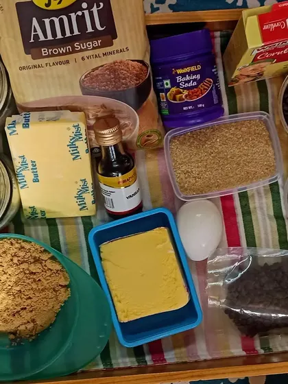 The ingredients for our children's day special: whole wheat choco-chip cookies. I focus on using healthier alternatives like brown sugar and whole wheat flour in our baking activities.
