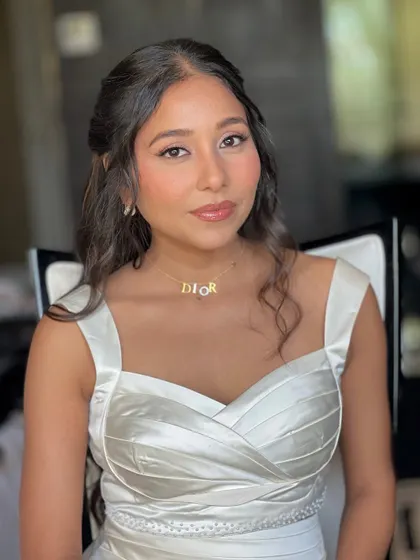 A simple and elegant look for a pre wedding event. The focus is on clean skin and a glossy lip, paired with a classic white dress.