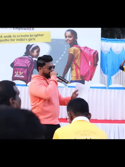 On stage at the CRY event, with the 'Walk to EmpowHER' banner in the background.