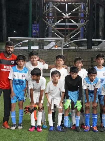 The team listens intently to their coaches before a game, a moment of focus and unity.