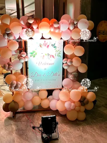 A lovely welcome easel for the twins' Boho-themed party, framed with balloons in warm, earthy tones.