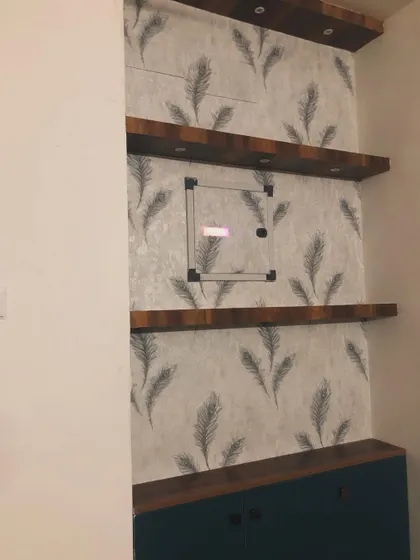 A slightly different angle of the shelving unit with the feather wallpaper.