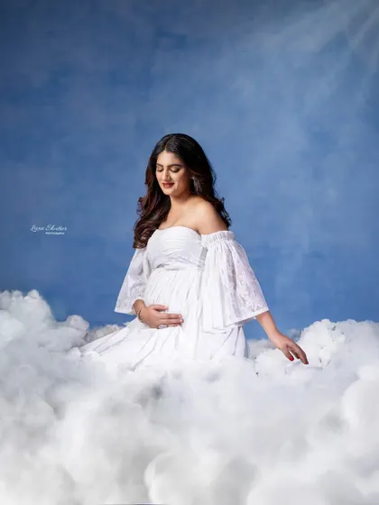A truly magical concept. By surrounding the mother-to-be with soft, cloud-like props, we create the illusion that she is floating in the sky, a heavenly vision in white.