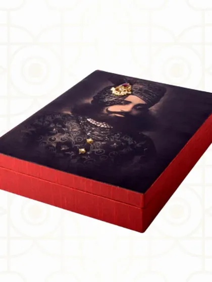 This striking trousseau box features a portrait of a Maharaja, embellished with small jewels. It's a bold and regal choice for a groom's gift or as part of a royal-themed wedding.