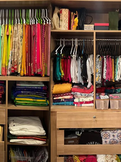 This is a great example of a fully organized ethnic wardrobe. We have hanging sarees, folded silks, and separate sections for blouses and accessories, creating a complete system.