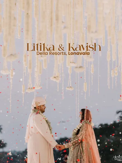 A fairytale moment for Litika and Kavish. Standing under a canopy of cascading white floral strings, this shot captures the dreamy, ethereal atmosphere of their wedding at Della Resorts.