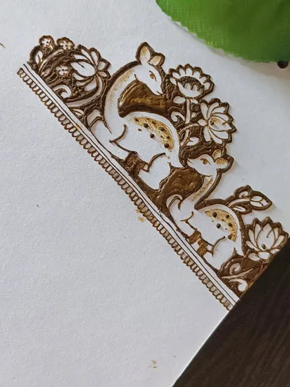 A close-up of the finished deer design, showing the delicate flowers and leaves surrounding the animals.