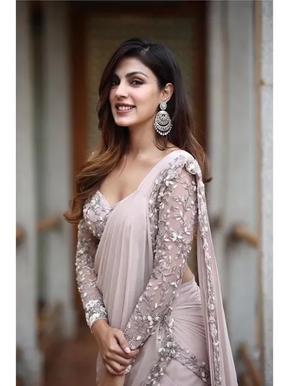 A soft and feminine look for Rhea Chakraborty. This tiered ruffle saree by Shloka Khialani in a dusty pink is modern, romantic, and incredibly chic.