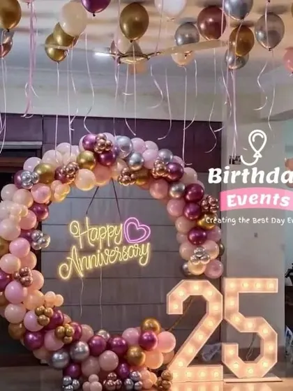 Our ring backdrops are perfect for anniversaries too. This 25th anniversary setup features a "Happy Anniversary" neon sign with a beautiful pink, purple, and gold balloon arrangement.