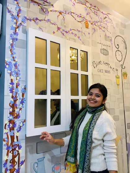 A happy moment with the completed mural. The custom window, which hides the circuit box, looks like a natural part of the charming scene.