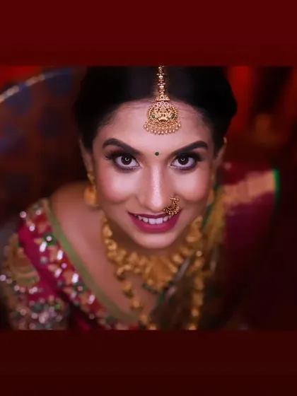 A creative, top-down shot of Rachana. This angle highlights the beautiful eye makeup and the traditional maang tikka.