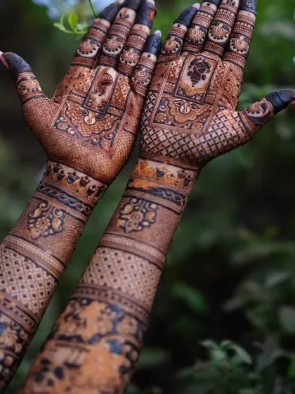 A detailed look at a back-hand design. The intricate patterns and the dark stain of the henna create a stunning contrast against the skin.