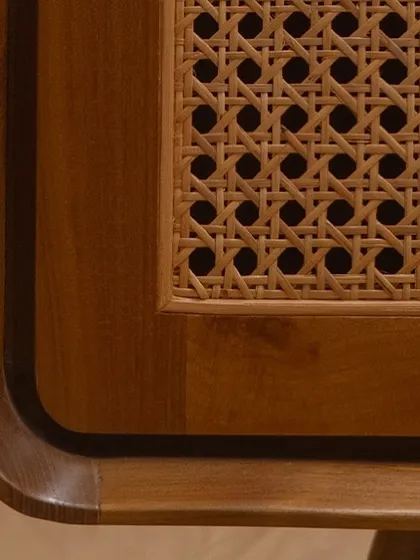 A close look at the corner of my 'Romaji' bench reveals the soul of my work. You can see the rich grain of the solid teak wood and the precision of the handwoven rattan. These are the details that ensure my furniture is not just beautiful, but enduring.