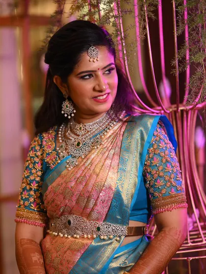 Rashmi's elegant side profile, showcasing her half-up hairstyle and the stunning details of her diamond jewellery.