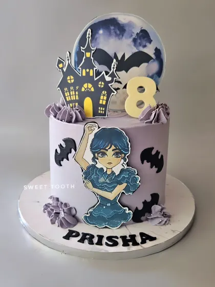 A spooky-cute Wednesday Addams cake for Prisha's 8th birthday. This cake captures the gothic vibe of the show with a haunted castle, bats, and a dancing Wednesday.