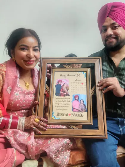 A happy couple with their 'Happy Married Life' frame. This design includes a calendar marking their special day, along with photos and a sweet message.