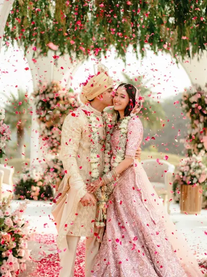 A moment of pure happiness, with a shower of petals celebrating the newlyweds. The pastel floral mandap in Udaipur provided the perfect romantic backdrop for this joyful shot.
