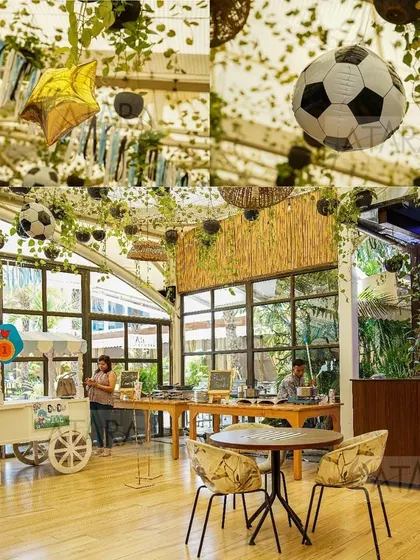 A collage showing the indoor setup of a soccer-themed party. The hanging vines and soccer balls from the ceiling create a unique and immersive atmosphere for the celebration.