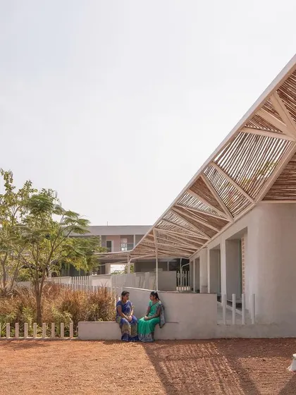 (Duplicate of 44) The simple, light-colored plaster walls provide a neutral backdrop to the vibrant life of the school and the rich textures of the landscape and bamboo canopy.
