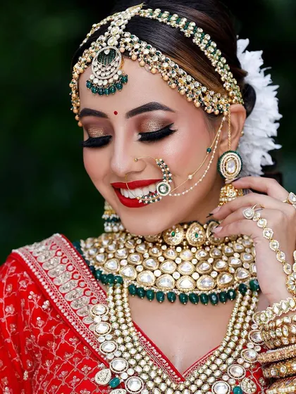 A happy bride smiling, adorned in a full Kundan set. Renting jewellery means you can have this picture-perfect moment without worrying about the cost.