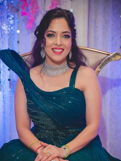 Our beautiful engagement bride Shraddha, looking radiant in her teal gown. The makeup features a soft smokey eye and a bright smile, ready for her celebration.