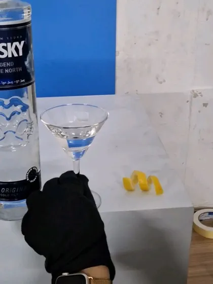 Styling the lemon peel garnish for the Husky Vodka cocktail shot.