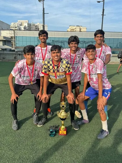 The full U18 squad with their trophy. Team photos like this capture the camaraderie and shared joy of victory that we foster in our academy.