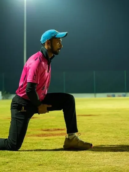 Aditya Mani stretching during a night practice session. We instill a professional work ethic, focusing on fitness and preparation at all hours.