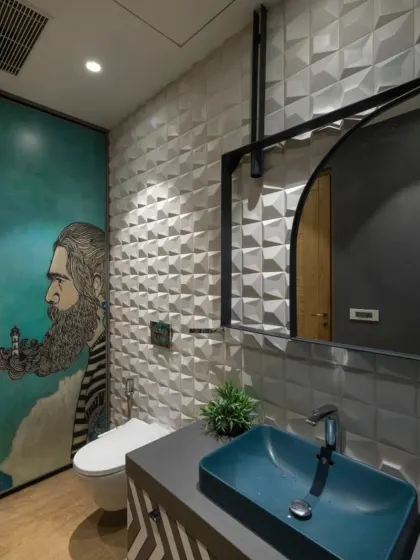 The bathrooms in the Screen House feature a dark, modern aesthetic. This one uses bold wallpaper, 3D wall panels, and a striking peacock blue washbasin to transform the space into a true wellness retreat.
