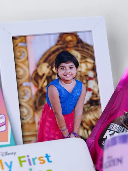 A close-up of the framed photo within the kid's hamper, surrounded by other fun goodies.