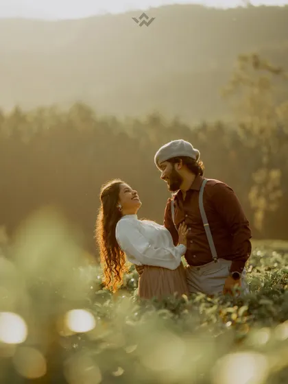 A beautiful, golden-hour shot of a couple in a tea field. We are experts at using natural light to create magical and romantic images.