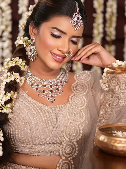 A soft, romantic pose. The makeup is kept fresh and minimal to let the bride's natural beauty and the intricate outfit shine.