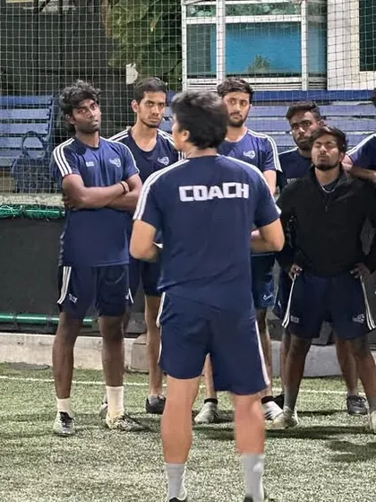 A group of our coaches listening intently during a training session. We believe in leading by learning.