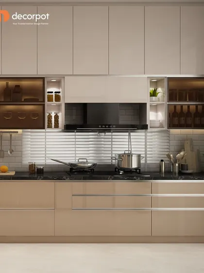 This kitchen features a neutral beige color palette with sleek, handleless cabinets. The textured white backsplash and under-cabinet lighting add depth and visual interest to the minimalist design.