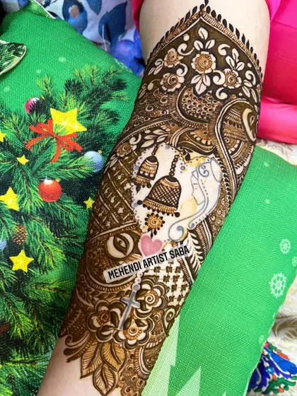 A slightly different angle of the Ganesha and temple bell design, showing the fine details and shading.