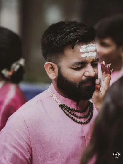 A candid moment of a guest participating in a wedding ritual.