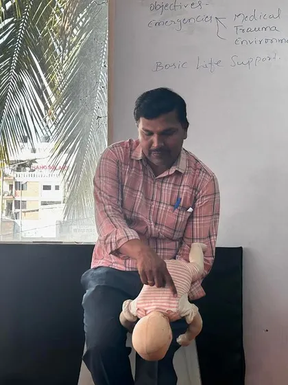 The instructor showing the correct procedure for infant CPR and first aid.