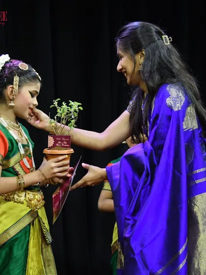 A teacher giving a final blessing to a young student before she goes on stage. These moments of connection and encouragement are at the heart of our teaching philosophy.