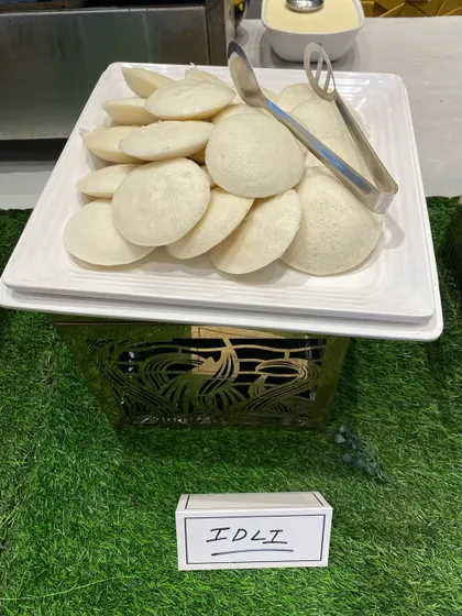 Soft and fluffy Idlis, a steamed rice cake that is a staple of South Indian breakfast, perfect with sambar and chutney.